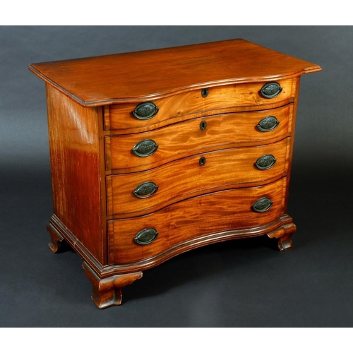 1479 - An American mahogany serpentine fronted chest, moulded oversailing top above four long graduated coc... 