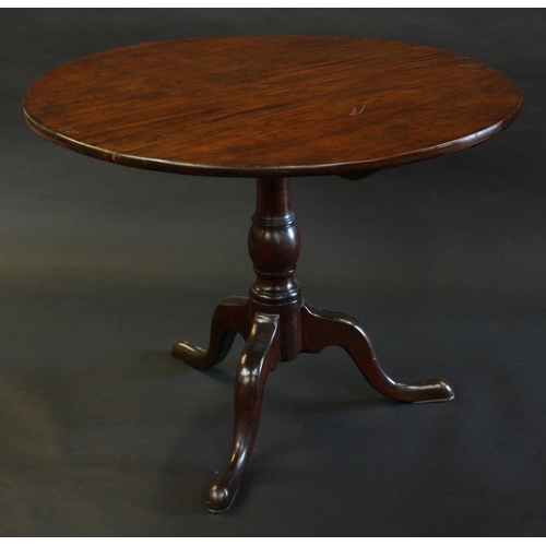 1485 - A George III mahogany tripod occasional table, circular tilting one piece top, turned baluster colum... 