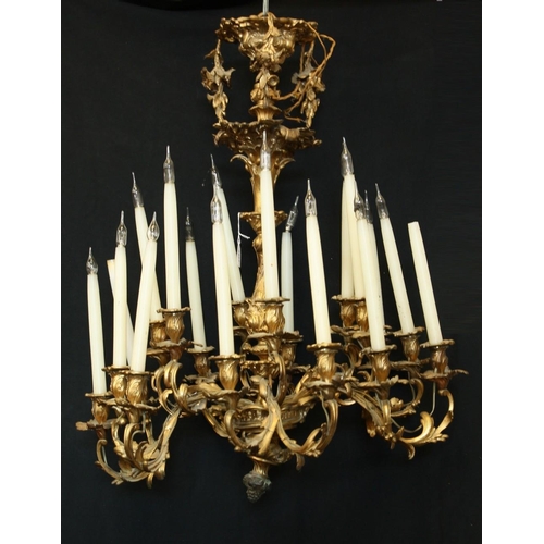 1491 - A Rococo Revival gilt metal eighteen-light chandelier, cast throughout with scrolling acanthus, camp... 