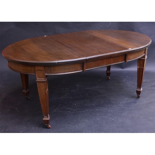 1516 - An Edwardian mahogany wind-out dining table, discorectangular shaped top above a deep frieze, tapere... 