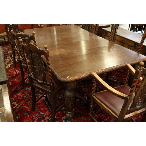 1517 - An early 20th century oak extending dining table, rounded rectangular top, turned legs carved with a... 