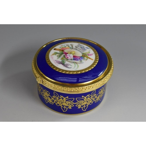 152 - A Lynton porcelain circular table box, painted by Stefan Nowacki, signed, with a musical trophy, wit... 