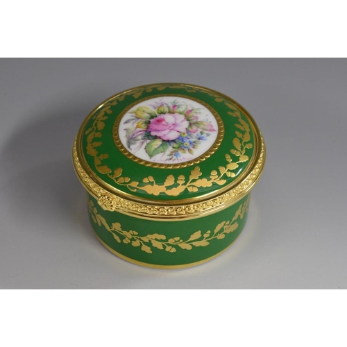 153 - A Lynton porcelain circular table box, painted by Stefan Nowacki, signed, with a spray of colourful ... 