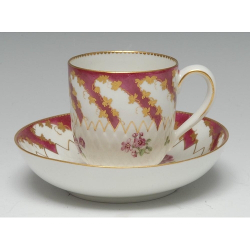 172 - A Chelsea-Derby 'artichoke-moulded' coffee cup and saucer, claret border with scrolling vine leaves ... 