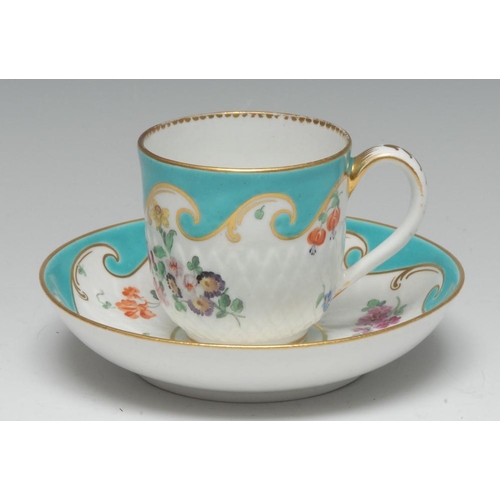 173 - A Chelsea-Derby 'artichoke-moulded' coffee cup and saucer, painted in polychrome enamels with scatte... 