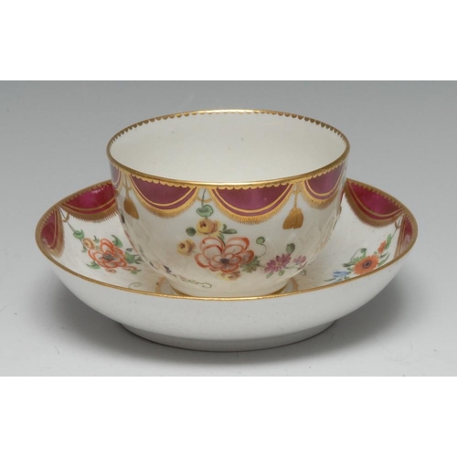 174 - A Chelsea-Derby 'artichoke-moulded' tea bowl and saucer, claret and gilt tasseled pelmet frieze abov... 