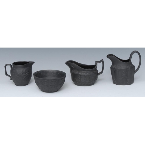 339 - A Wedgwood black basalt cream jug and sugar bowl, in relief with scrolls, 7cm high, impressed marks;... 