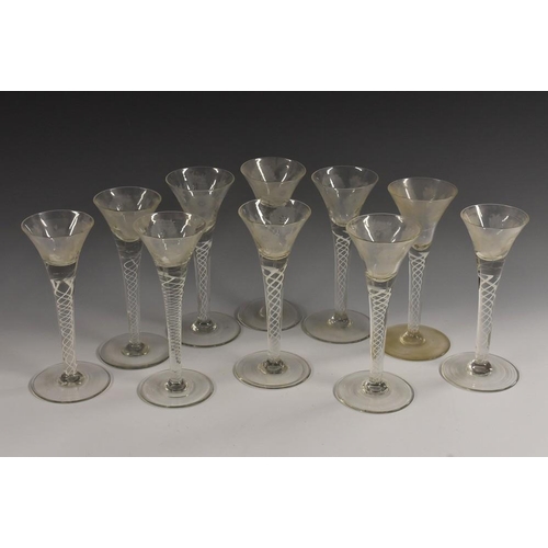 379 - A set of ten 19th century trumpet shaped opaque twist wine glasses, each bowl engraved with roses, c... 