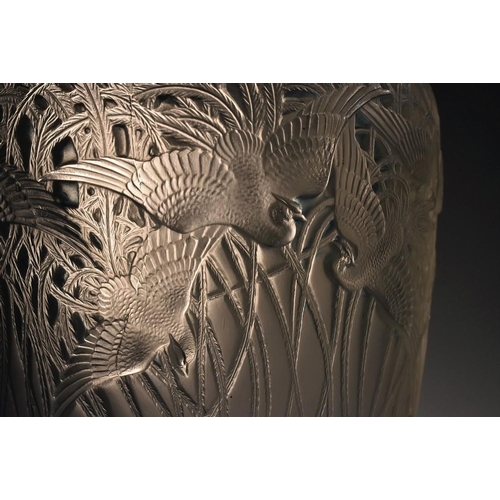 389 - A Rene Lalique ''Aigrettes'' pattern vase, of flared cylindrical form, the upper section moulded in ... 