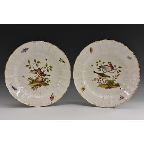 391 - A pair of Meissen fluted shaped circular plates, each painted in polychrome with birds perched among... 