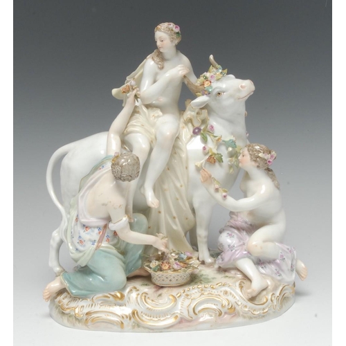 392 - A Meissen figure group, Europa and the Bull, painted in pale polychrome tones, applied with flowers ... 