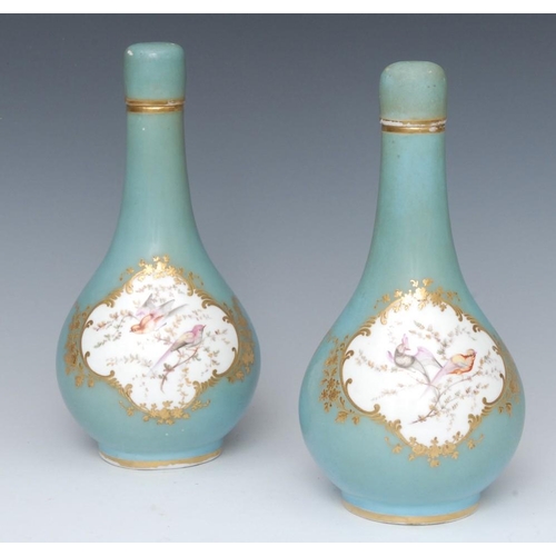 413 - A pair of English porcelain Sèvres style bottle vases and covers, decorated with fanciful birds perc... 