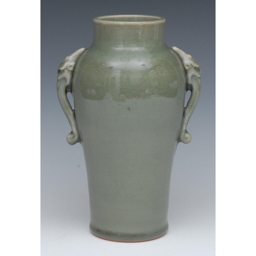 426 - A Chinese celadon ovoid vase, with elephant scroll handle, pierced hardwood bases, 23cm high, 19th c... 