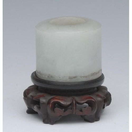 433 - A Chinese Jade archers thumb ring, cylindrical, 3.1cm high, carved wooden stand, 19th century or ear... 