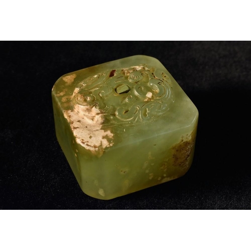 434 - A Chinese jade canted square seal, carved with stylised animals and scrolls, 4.5cm wide