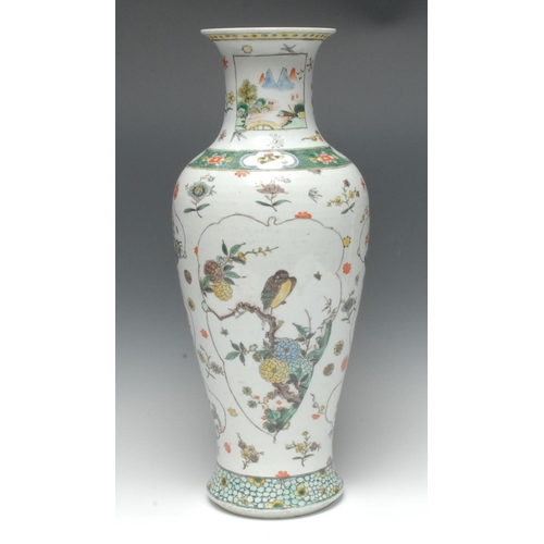 442 - A Chinese slender baluster vase, painted in the Famille Verte palette with birds perched on blossomi... 