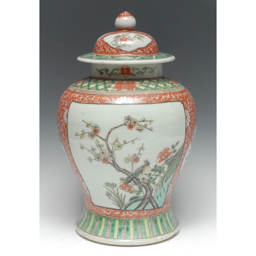 445 - A Chinese temple jar and cover, painted in the Kangxi manner in polychrome enamels with shaped reser... 