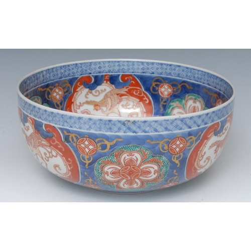 450 - A Japanese Imari bowl, the interior with cobalt blue foliate roundel, the sides with alternating sha... 