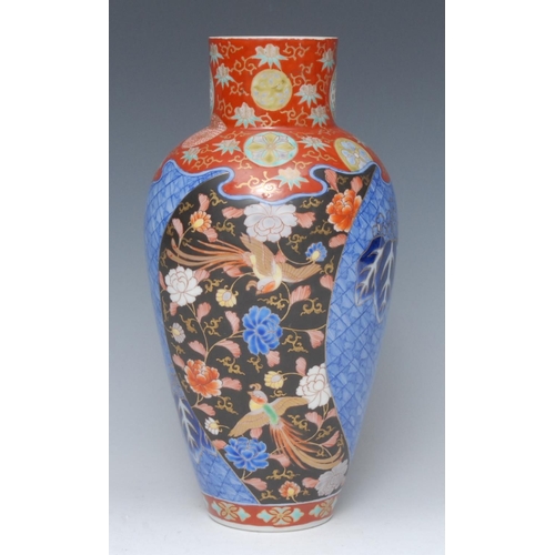 451 - A Japanese Kutani vase, decorated in polychrome with panels with birds of paradise amongst flowers, ... 