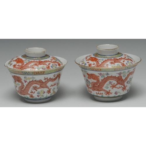 462 - A pair of Chinese flared circular bowls and covers, each painted in polychrome and picked out in gil... 