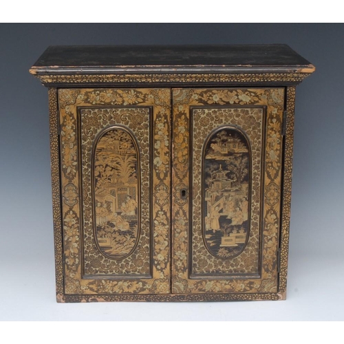 480 - A Chinese lacquer table cabinet, moulded cornice above a pair of rectangular raised panelled doors e... 