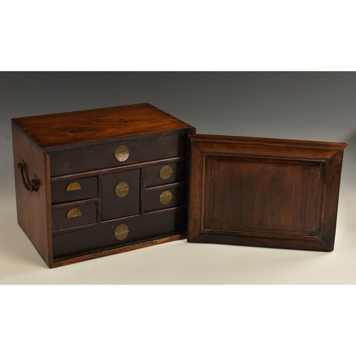 492 - A Chinese hardwood rectangular table cabinet, sliding rectangular panelled door enclosing an arrange... 