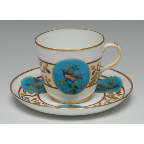 65 - A Minton cup and saucer, well-painted in polychrome with domestic and exotic birds on fruiting trees... 