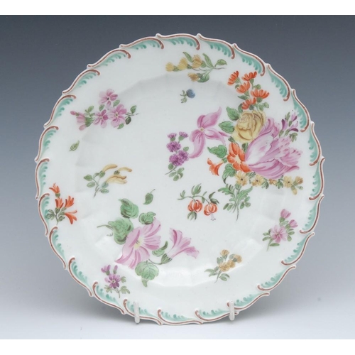 78 - A Chelsea shaped circular plate, painted with tulips and summer flowers, feathered rim, in relief, 2... 