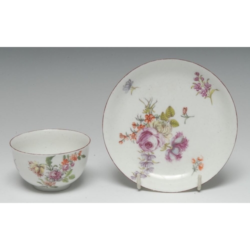 86 - A Chelsea tea bowl and saucer, finely painted in polychrome enamels with Deutsche Blumen, iron red r... 