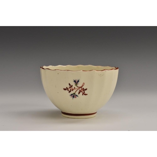 90 - A Pinxton fluted tea bowl, of the larger size, pattern no. 1, decorated with red sprigs and blue cor... 