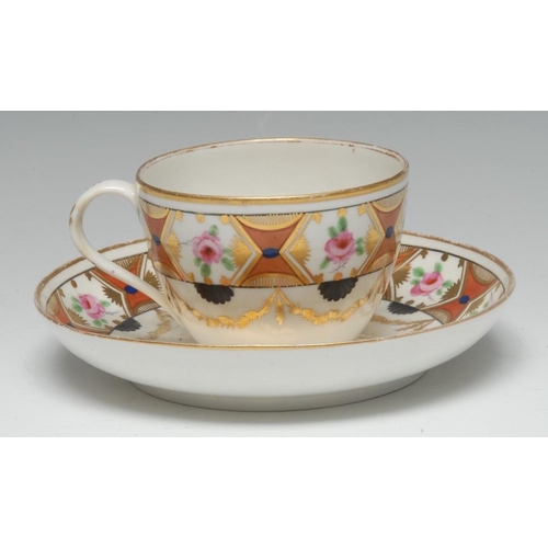 97 - A Pinxton Bute-shaped teacup and saucer, painted with a frieze of pink roses in hexagonal gilt reser... 