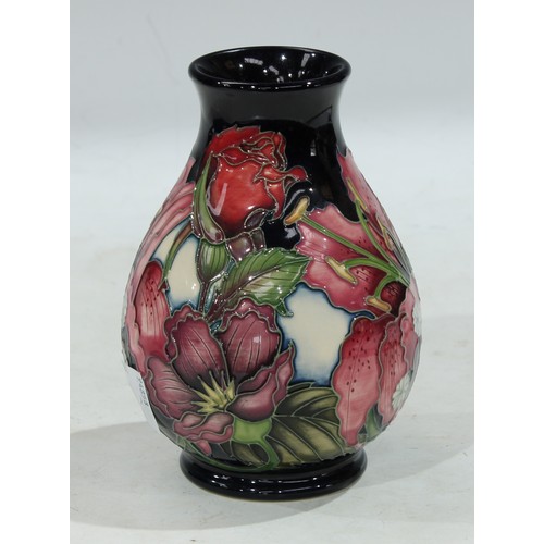 125 - A contemporary Moorcroft inverted baluster vase, applied with roses and irises, 14cm, boxed