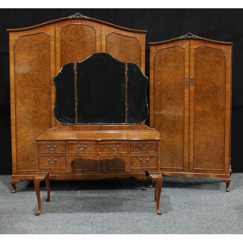 92 - A 20th century art deco burr walnut veneered bedroom suite, comprising a triple wardrobe, Hunters of... 