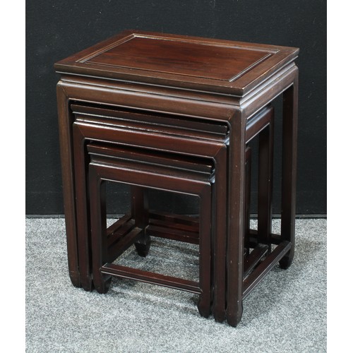 99 - A Chinese style hardwood nest of three occasional tables, rectangular panel tops, manufacturers labe... 