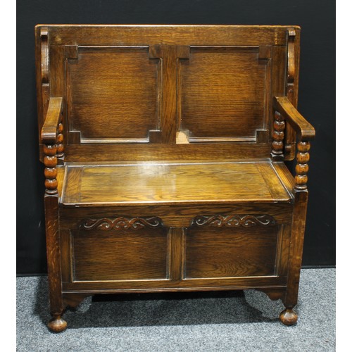 155 - An early 20th century oak monks bench, 93cm high, 91cm wide.