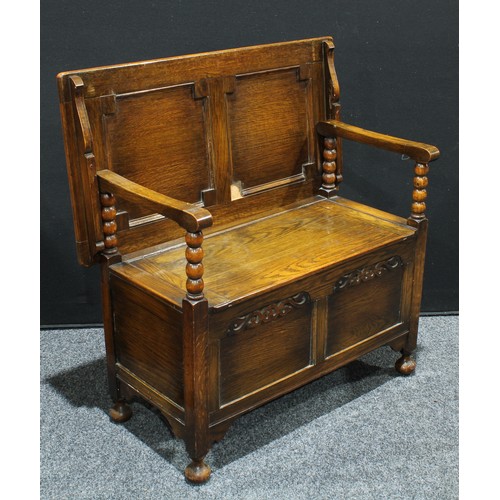 155 - An early 20th century oak monks bench, 93cm high, 91cm wide.