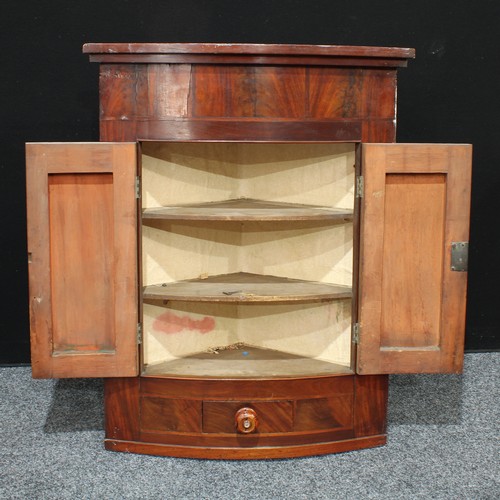 160 - A Georgian flame mahogany bow front corner cabinet