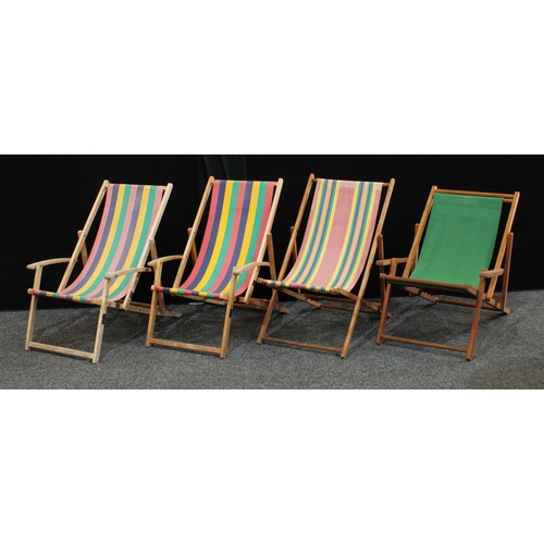 221 - 1970s and late wooden and canvas folding deck chairs. (4)