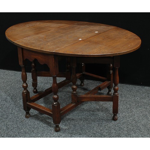 228 - A 17th century style oak gateleg dining table