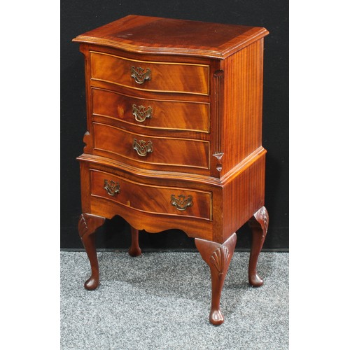 231 - A reproduction mahogany side cabinet, serpentine top above four small cockbeaded drawers, shaped apr... 