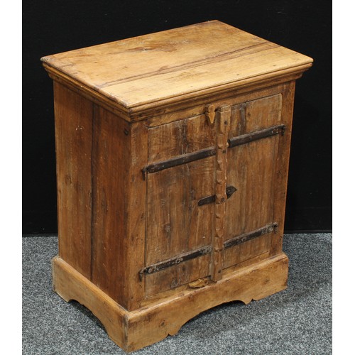 239 - A small rustic style hardwood cupboard, rectangular top above a pair of cupboard doors enclosing she... 