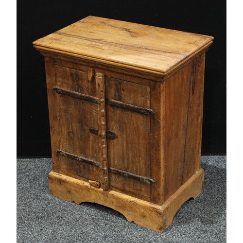 239 - A small rustic style hardwood cupboard, rectangular top above a pair of cupboard doors enclosing she... 