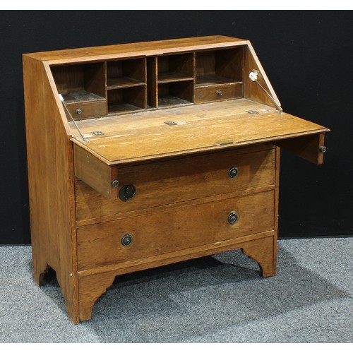 309 - A 20th century oak bureau, fall front enclosing an arrangement of pigeon holes and two small drawers... 