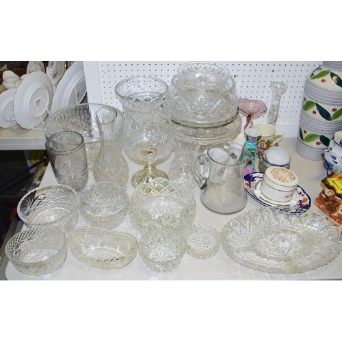 111 - A large cut glass pedestal fruit bowl; others smaller; a cut glass claret jug, vases, cake stands et... 