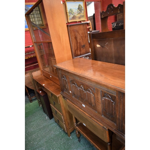 541 - An oak buffet/serving trolley; a linen fold blanket chest; a mahogany fall front purdonium; a slidin... 