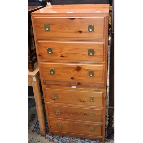 548 - A pair of pine bedside cabinets, in the campaign taste with flush brass handles