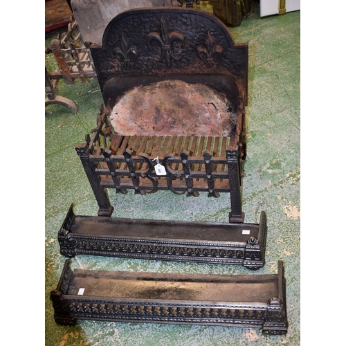 549 - A cast iron fire basket, arched back applied with fleur-de-lis; two similar fenders (3)