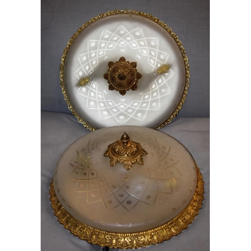 557 - A pair of flush mounted ceiling lights, frosted shades, 'gilt' metal mounts (2)