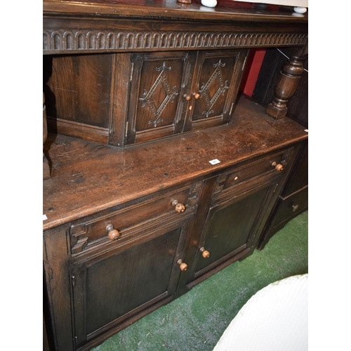 567 - An oak court cupboard, rectangular top above a nulled frieze and a pair of small doors, the base wit... 