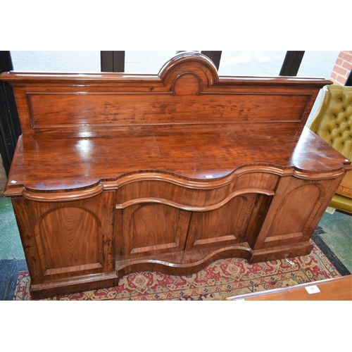 60 - A substantial Victorian mahogany sideboard, shaped serpentine top with bold half gallery above a fri... 